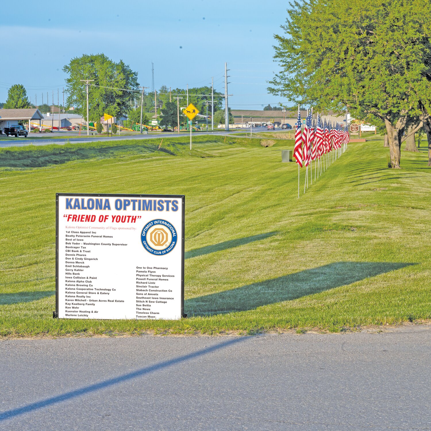 There were 37 flags sponsored by Kalona businesses and individuals flown for the first time Memorial weekend. Sign recognizing flag sponsors is at left (west end of City Park). The flags, located along Southside of Highway 22, will be flown every holiday that the other 360 Optimists Community Of Flags are flown throughout Kalona.